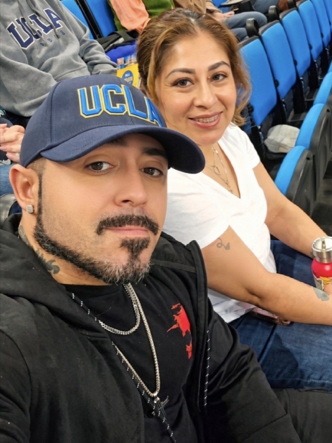 Jose and his wife at a game