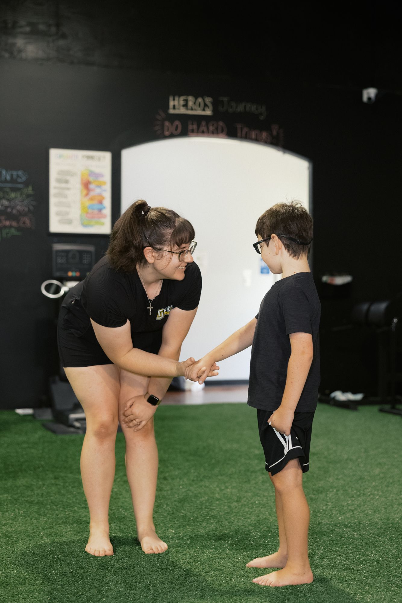 A coach meeting her young athlete at eye level